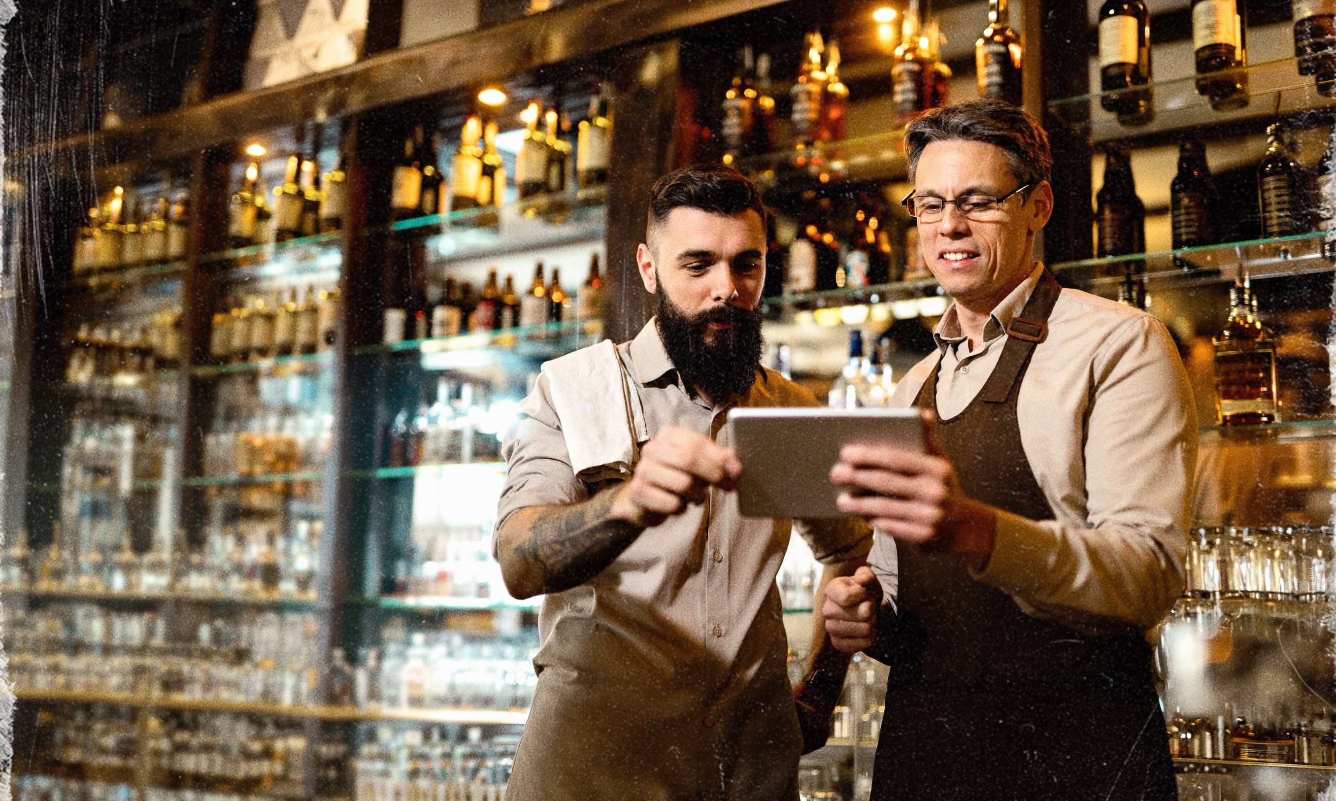 A bartender mixing a cocktail behind the bar