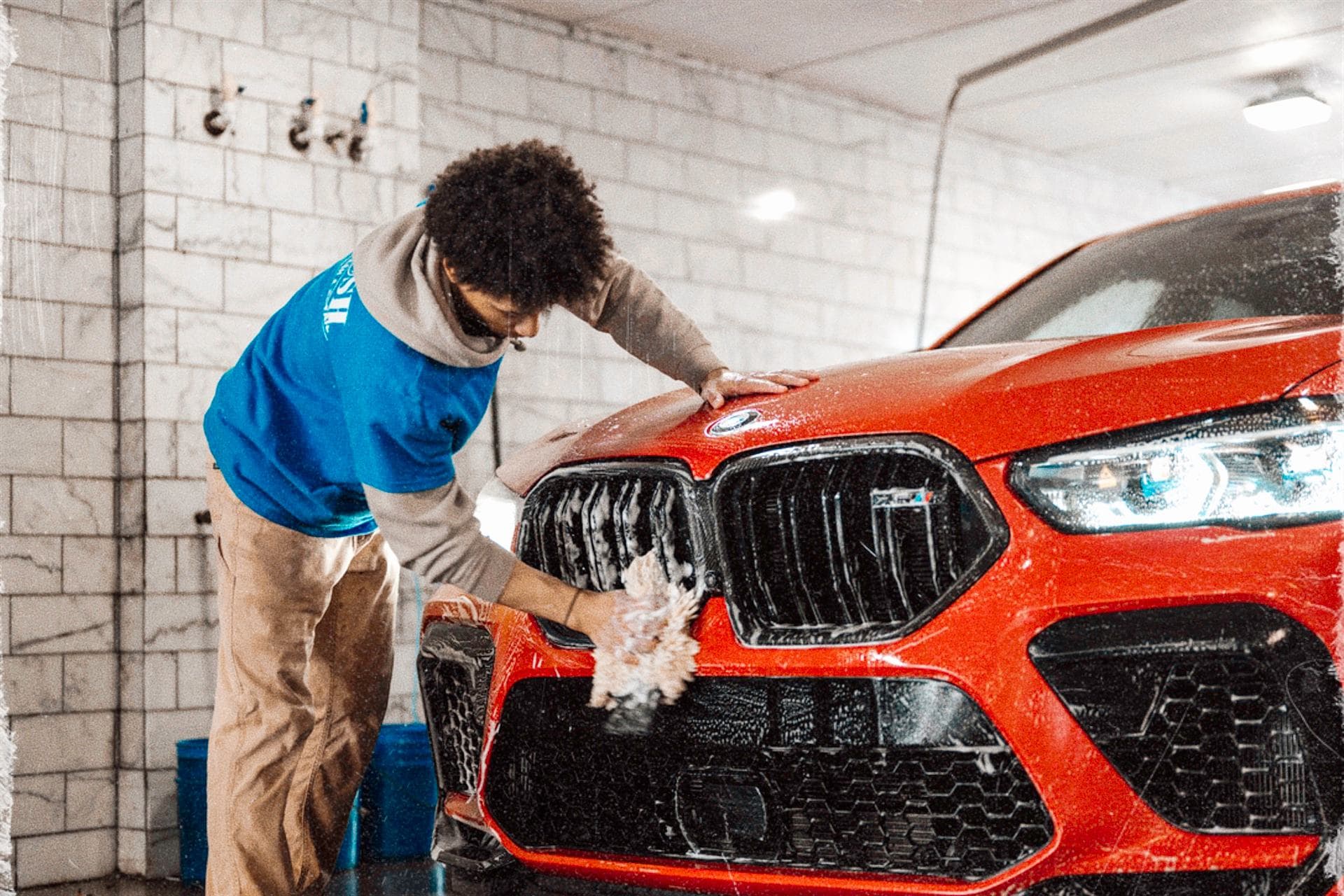 A hand car wash crew finishing a vehicle